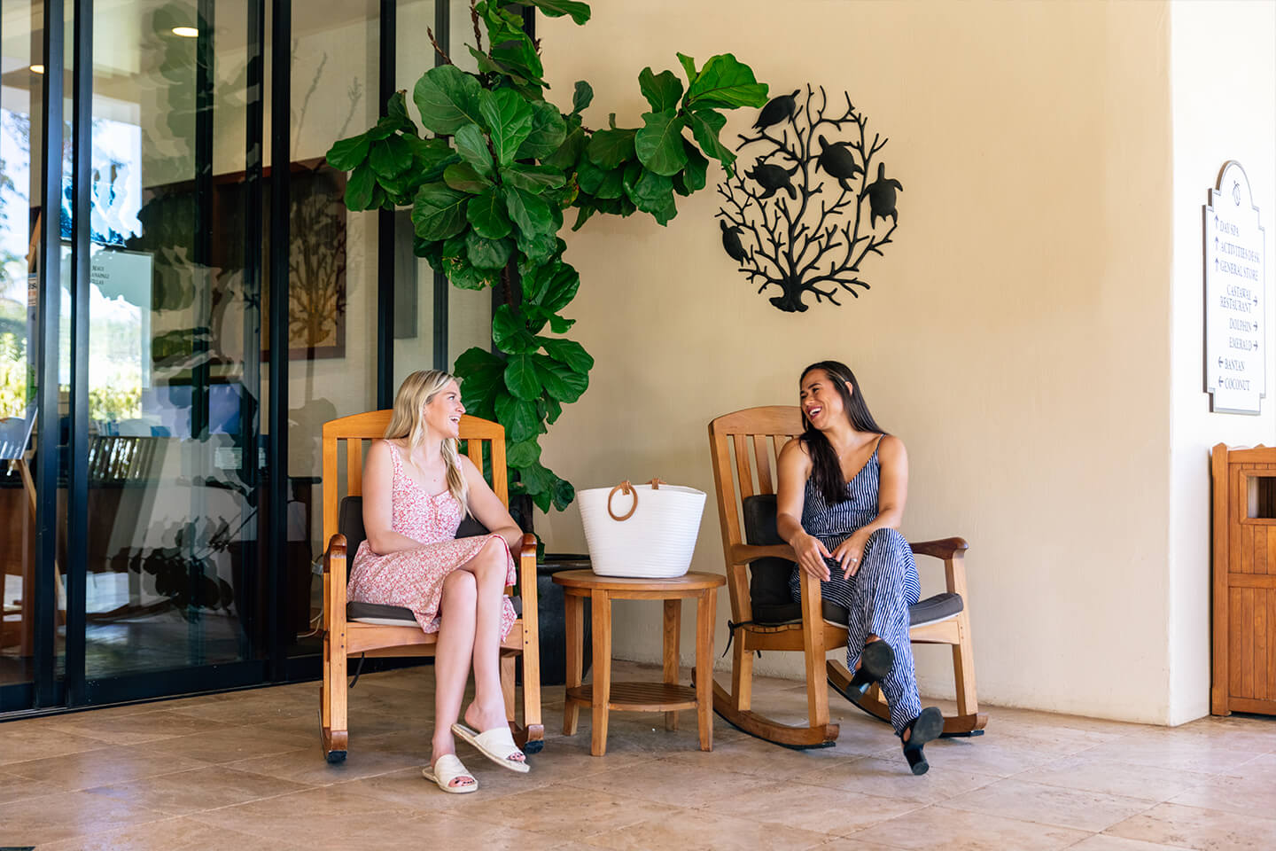 2 woman sitting in open-air lobby