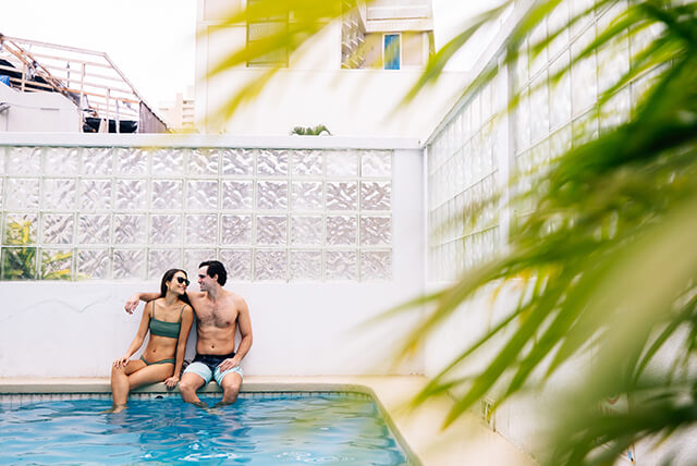 Couple relaxing on edge of pool