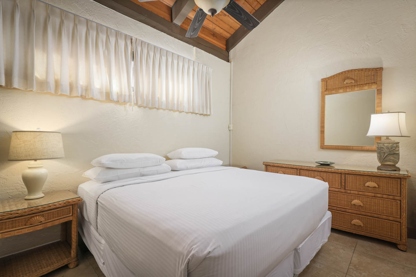 2-Bedroom Oceanfront Bedroom with bed, nightstand and lighting