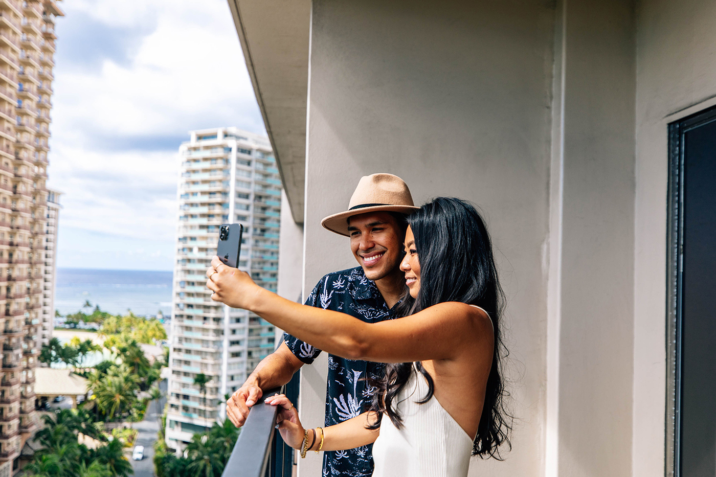 Couple taking selfie photo on balcony