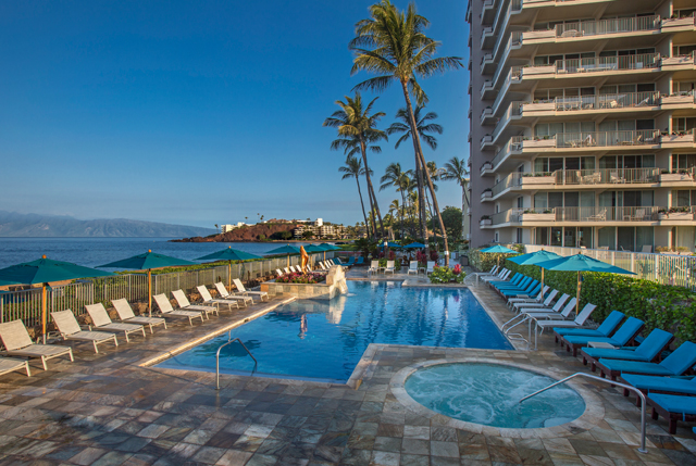 Swimming pool and beach chairs on property ground.