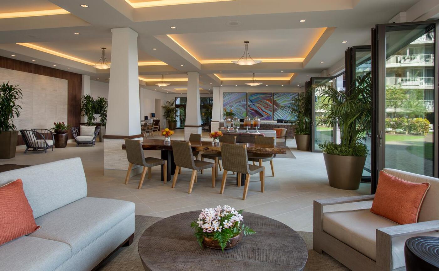 Open-air lobby area with couches, seating, tables