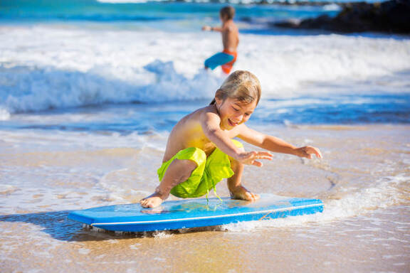 ss_162352214-young-boy-surfing.jpg