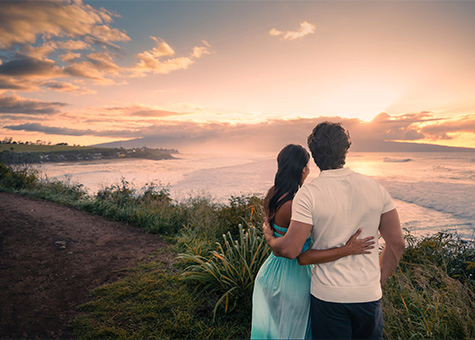 couple holding each other watching sunset